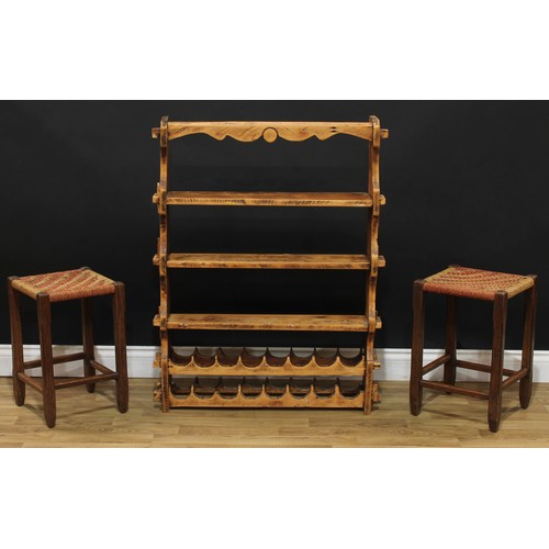 617 - A pine kitchen shelf with wine rack, 102cm high, 79cm wide, 16.5cm deep; two rope seat stools, 47cm ... 