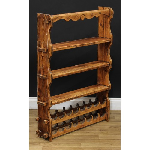 617 - A pine kitchen shelf with wine rack, 102cm high, 79cm wide, 16.5cm deep; two rope seat stools, 47cm ... 