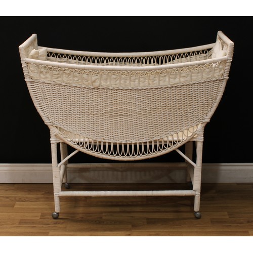 619 - A white painted wicker baby doll crib or cot, 92cm high, 107cm long, 50cm wide