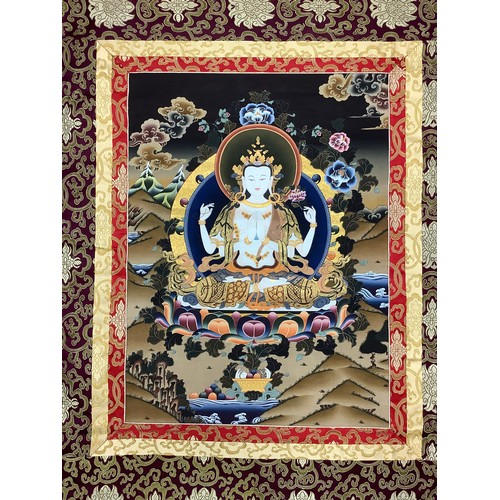 632 - A Tibetan wall hanging scroll, central panel with Tara, approximately 130cm x 85cm