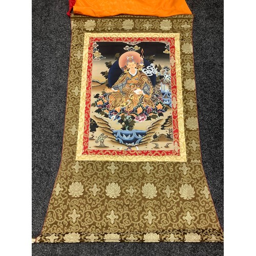 633 - A Tibetan wall hanging scroll, central panel with Guru Rinpoche, approximately 130cm x 80cm