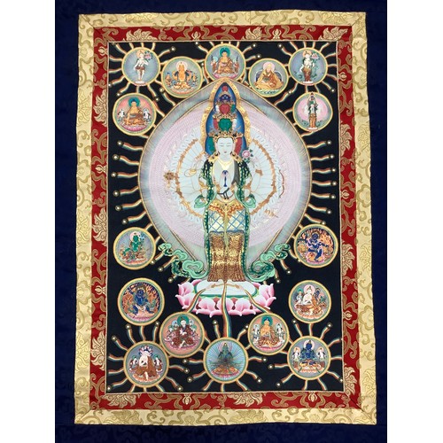 634 - A Tibetan wall hanging scroll, central panel with Thousand Arm Buddha, approximately 130cm x 80cm