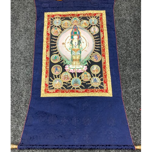 634 - A Tibetan wall hanging scroll, central panel with Thousand Arm Buddha, approximately 130cm x 80cm