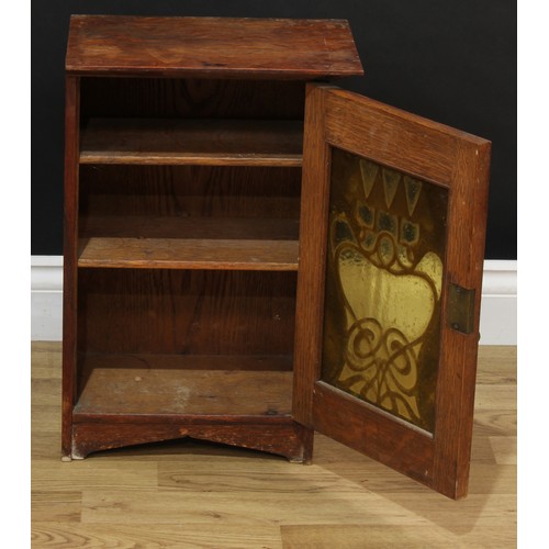 120A - An Art Nouveau oak wall hanging cabinet, copper fretwork overlaid glazed door enclosing two shelves;... 