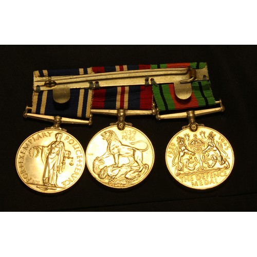 653 - World War II medals, a set of three 1939 - 1945 Defense medal, Service medal, For Exemplary Police S... 