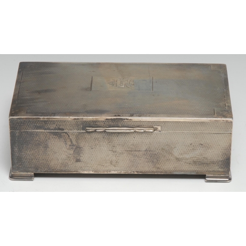 268 - An Art Deco silver rectangular cigarette box, engine-turned, hinged cover, geometric bracket feet, c... 