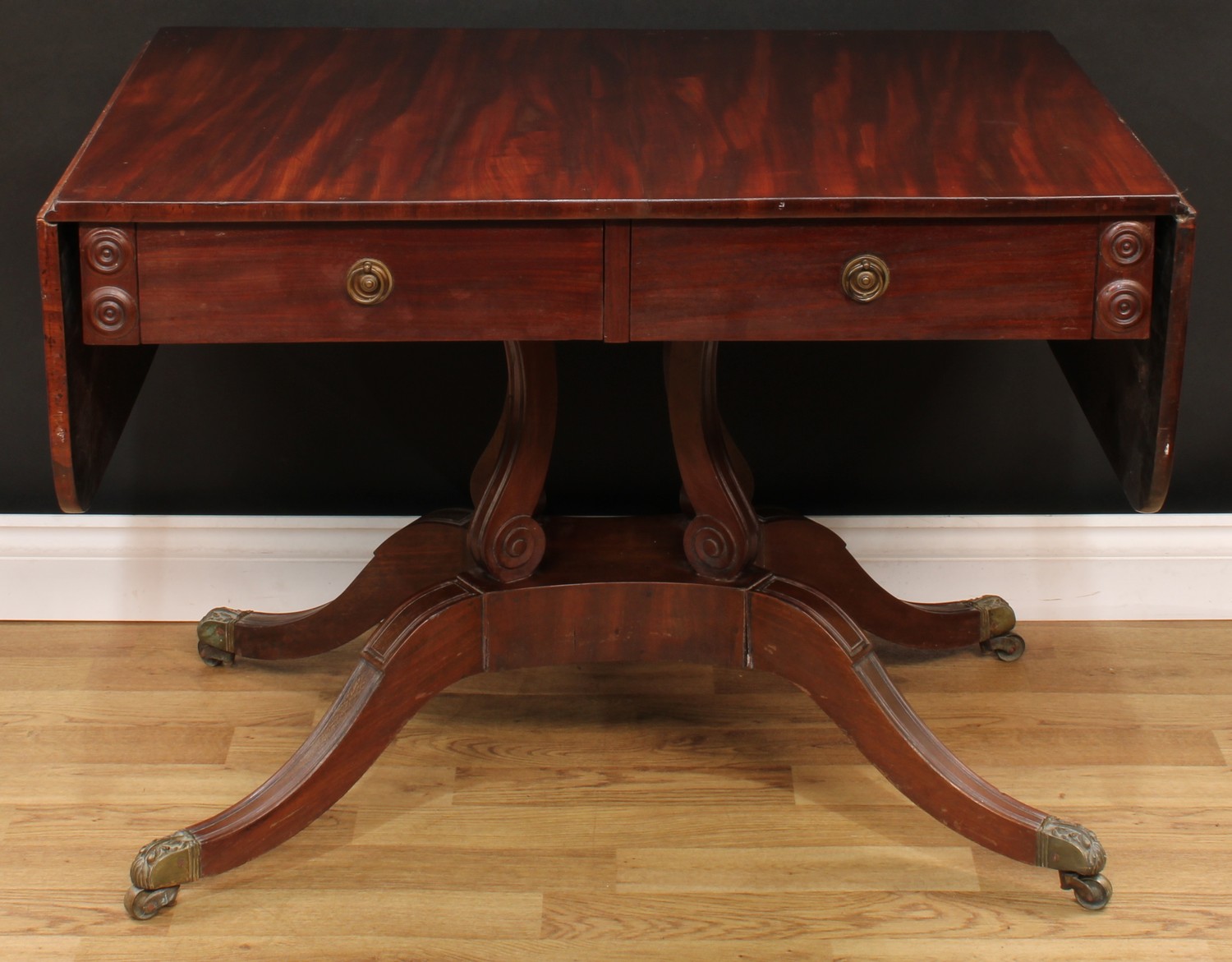 A William IV mahogany sofa table, rectangular top with fall leaves above a...