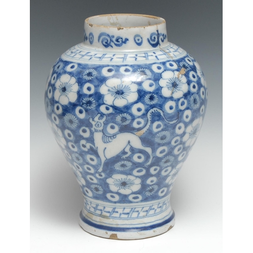 442 - An 18th century Delft  ovoid jar, tin glazed in the Chinese taste with dragons on a ground of blosso... 