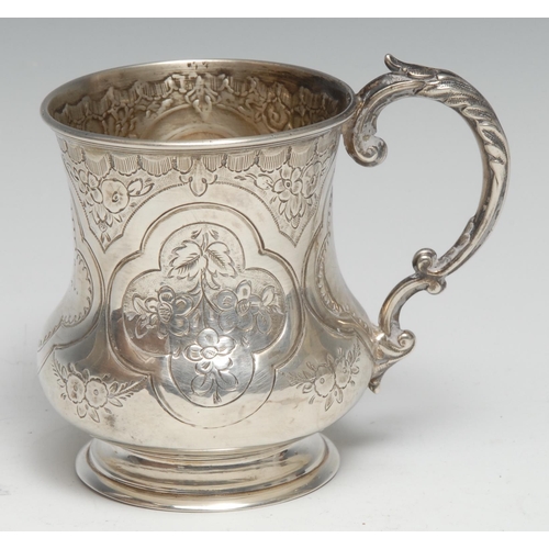 235 - A Victorian silver christening mug, chased and engraved with flowers and stiff leaves within Gothic ... 