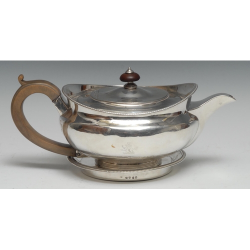 201 - A Regency silver lamp shaped teapot and circular stand, flush-hinged domed cover, egg-and-dart borde... 