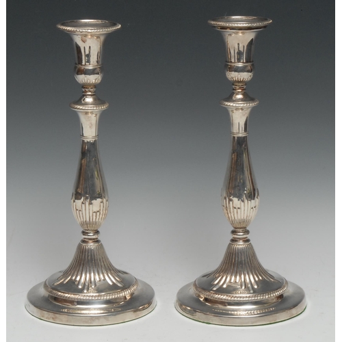 319 - Matthew Boulton - a pair of George III silver table candlesticks, campana sconces with detachable no... 