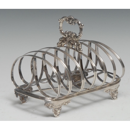 284 - An early Victorian silver seven-bar toast rack, leafy loop handle, arched divisions, cartouche shape... 