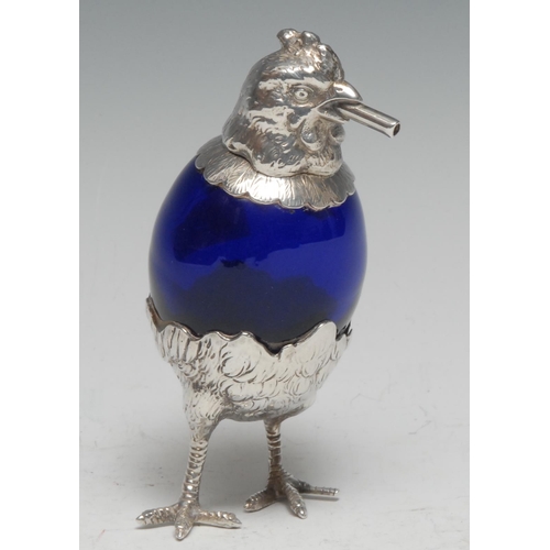 276 - An early 20th century silver coloured metal novelty cigar lighter, as a chicken, blue glass egg shap... 