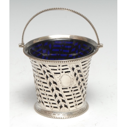 120 - A George III silver swing handled cream basket, pierced and bright-cut engraved with wriggle-work, b... 