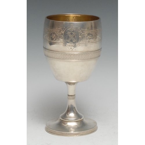 332 - Tiffany & Co - an American silver pedestal wine goblet, engraved with a band of scrolling foliage an... 