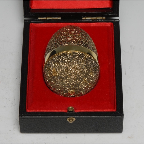 328 - Stuart Devlin (1931 - 2018) - an Elizabeth II silver-gilt and silver surprise egg, Jack in the Box, ... 