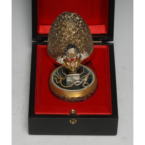 328 - Stuart Devlin (1931 - 2018) - an Elizabeth II silver-gilt and silver surprise egg, Jack in the Box, ... 