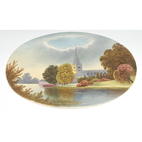 446 - An English Pottery oval ceramic plaque,  painted with a view of a cathedral by river, 33cm wide,  c.... 