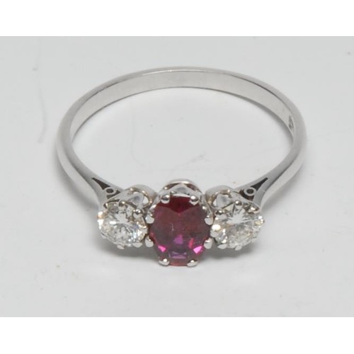 351 - A diamond and ruby trilogy ring, central oval vibrant red ruby approx 0.85ct, between a pair of roun... 