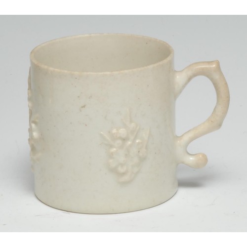 476 - A Bow Blanc de Chine coffee can, typically applied with blossoming prunus, unusual scroll handle, 6c... 