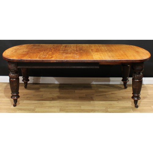 1972 - A Victorian oak extending dining table, discorectangular top with moulded edge and one additional le... 