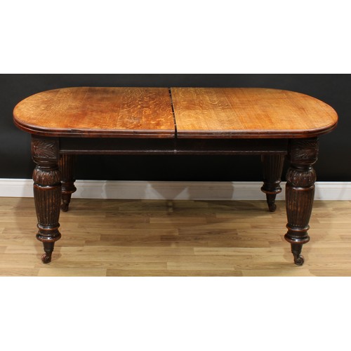 1972 - A Victorian oak extending dining table, discorectangular top with moulded edge and one additional le... 