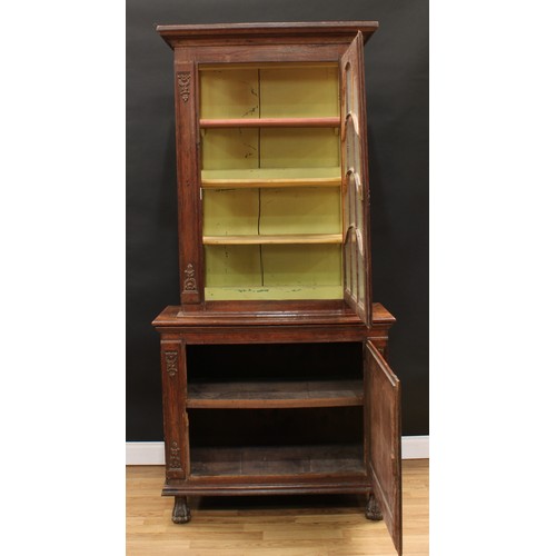 1976 - An 18th century Continental oak display cabinet, outswept cornice above an astragal glazed door encl... 