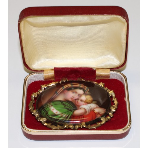 651 - An Italian late 19th century oval painted porcelain brooch, Madonna and Child, mounted in a Pinchbec... 