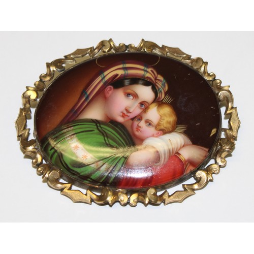 651 - An Italian late 19th century oval painted porcelain brooch, Madonna and Child, mounted in a Pinchbec... 