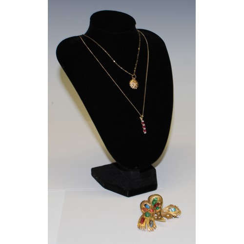 652 - A 9ct gold diamond chip and ruby pendant on a 9ct gold necklace chain, marked 375, a 9ct gold sunbur... 