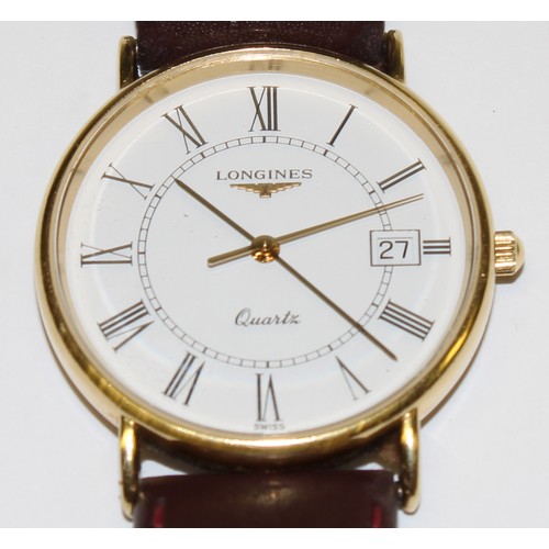 653 - A Longines watch, white dial, Roman numerals, date aperture, centre seconds, brown leather strap, bo... 