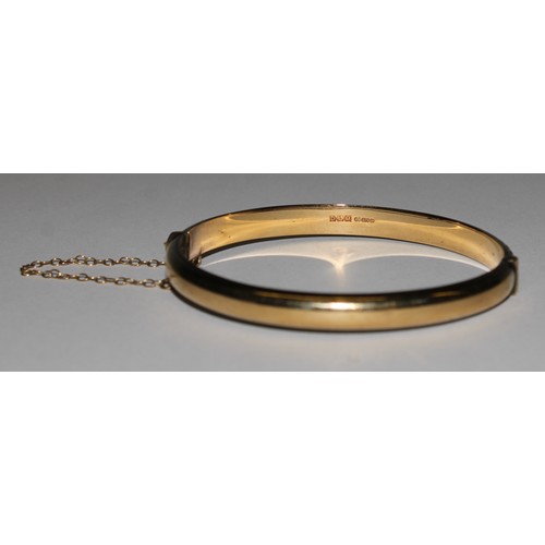 663 - A 9ct gold hinged bangle, 8.8g