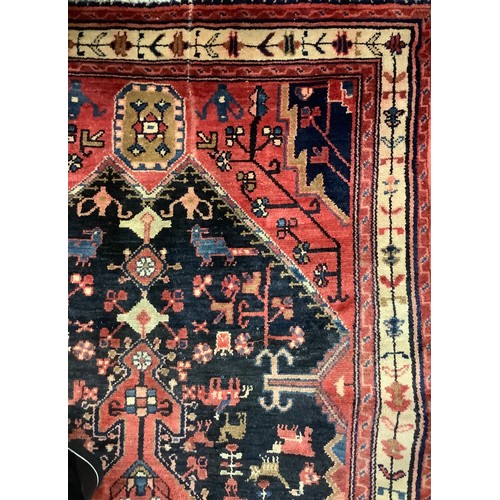 70 - A Hamadan carpet in tones of petrol blue and claret, central geometric pole medallion, 215cm x 110cm