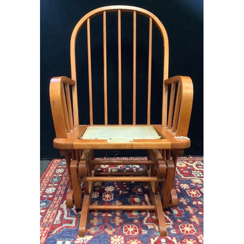 A Dutailier 20th century pine bentwood rocking chair 100cm high