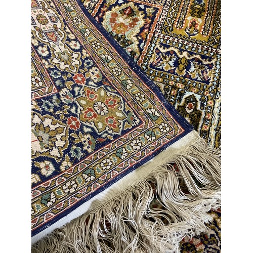 100 - A Persian Silk and Wool Carpet, the central marquette-filled Field enclosed by a stylised floral bor... 