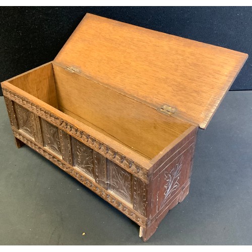 107 - Miniature Furniture  - a carved blanket box, scrolled plank top, leaf carved four panel front, stile... 