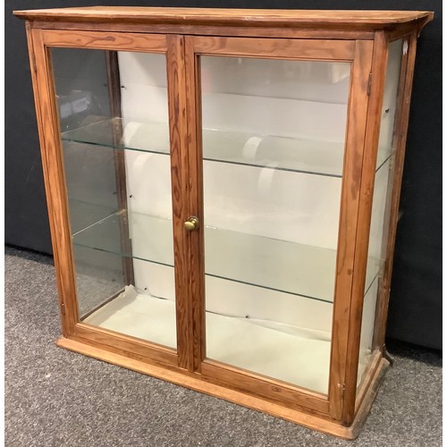 115 - A Victorian wall mountable pine display cabinet, glazed sides and pair of doors enclosing two tiers ... 