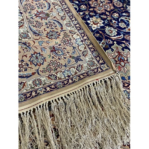 124 - A Persian Isfahan Rug, the fine, short wool pile and silk carpet woven in shades of deep blue, azure... 