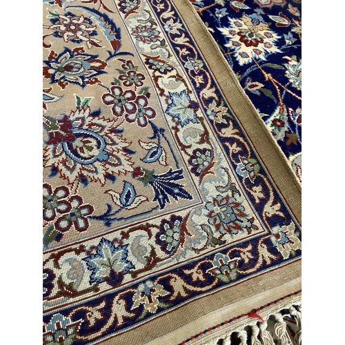 124 - A Persian Isfahan Rug, the fine, short wool pile and silk carpet woven in shades of deep blue, azure... 