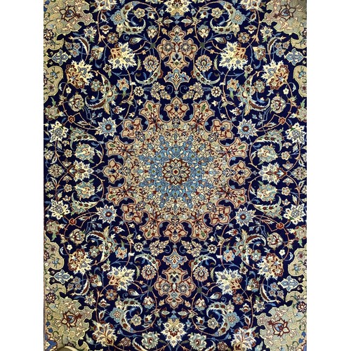 124 - A Persian Isfahan Rug, the fine, short wool pile and silk carpet woven in shades of deep blue, azure... 