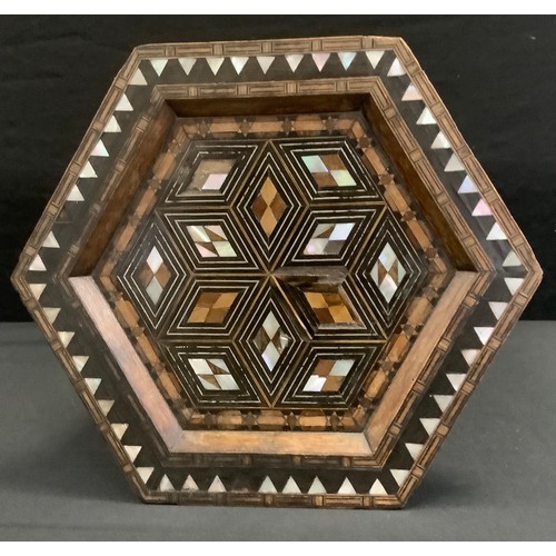 128 - An Anglo Indian Moorish design inlaid hexagonal side table, geometric top inlaid with mother of pear... 