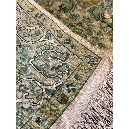 133 - A Pair of Persian Isfahan type Rugs, the wool pile and silk carpets in subdued shades of green and j... 