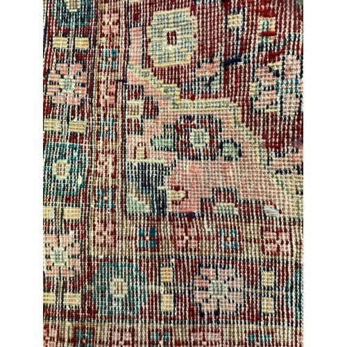 136 - A Hamadan carpet, central geometric medallion in tones of cream, bule and claret, 214cm x 127cm