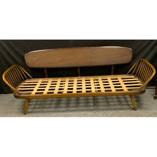 251 - An Ercol Studio range Elm daybed sofa, shaped panel back, with original patterned seat cushion ( the... 