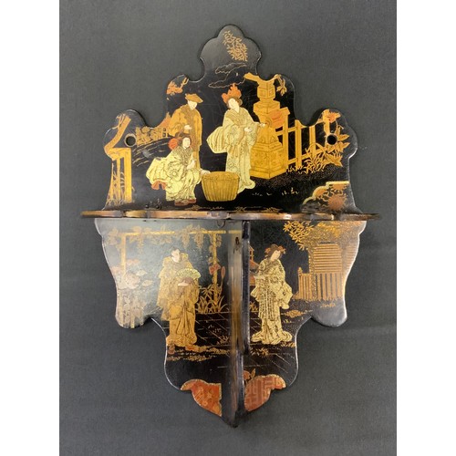 392 - A Japanese lacquer folding shelf, decorated with traditional figures in landscapes, shaped back and ... 