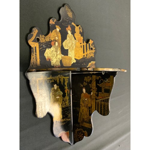 392 - A Japanese lacquer folding shelf, decorated with traditional figures in landscapes, shaped back and ... 