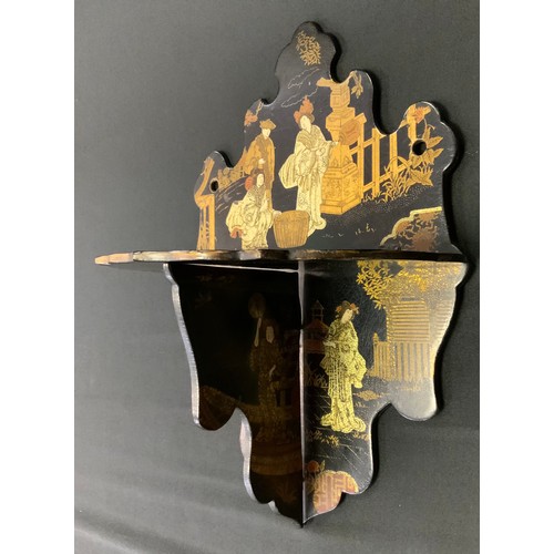 392 - A Japanese lacquer folding shelf, decorated with traditional figures in landscapes, shaped back and ... 