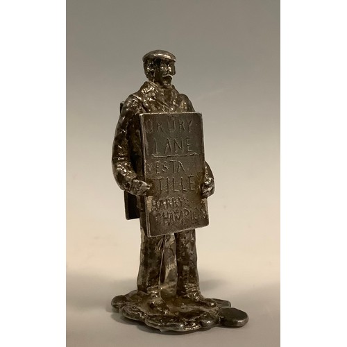 429 - A hallmarked silver place card/menu holder modelled as a man with a sandwich board advertising shows... 