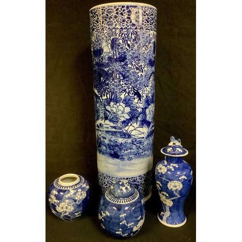 87 - A Chinese blue and white cylindrical stick stand; a Chinese prunus pattern blue and white inverted b... 