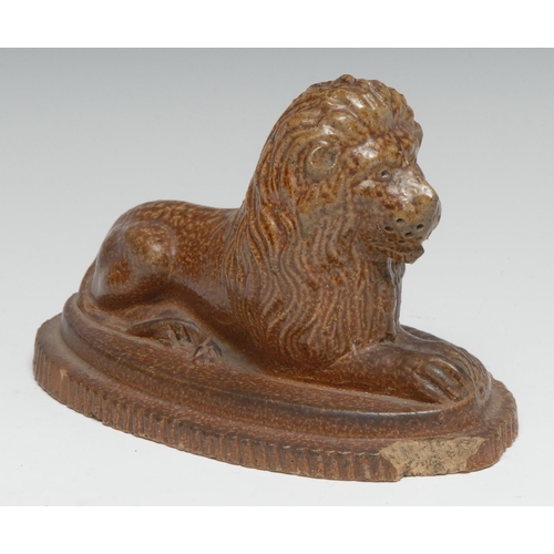 287 - A 19th century salt glazed stoneware model, of a recumbent lion, shaped oval base, 16.5cm long